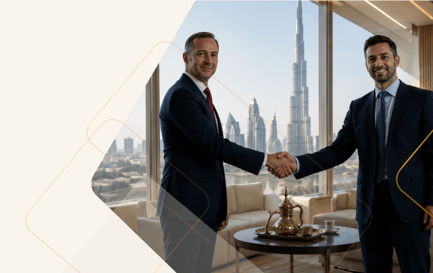 Two business partners shaking hands in a Dubai office overlooking the Burj Khalifa